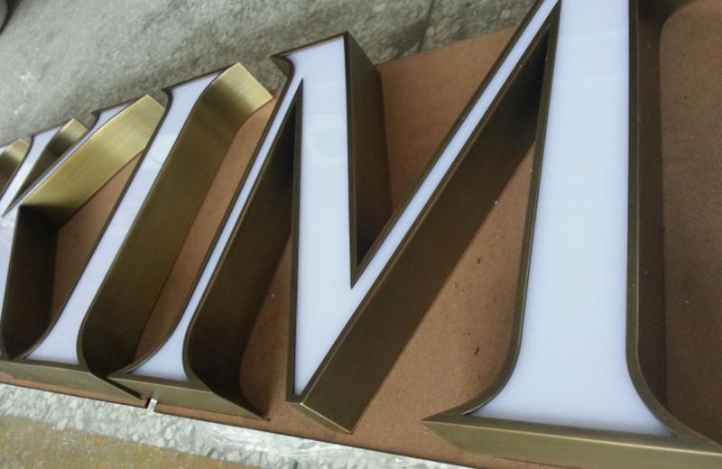 aged-brass-detailed-logo-close-up-of-sign-letters