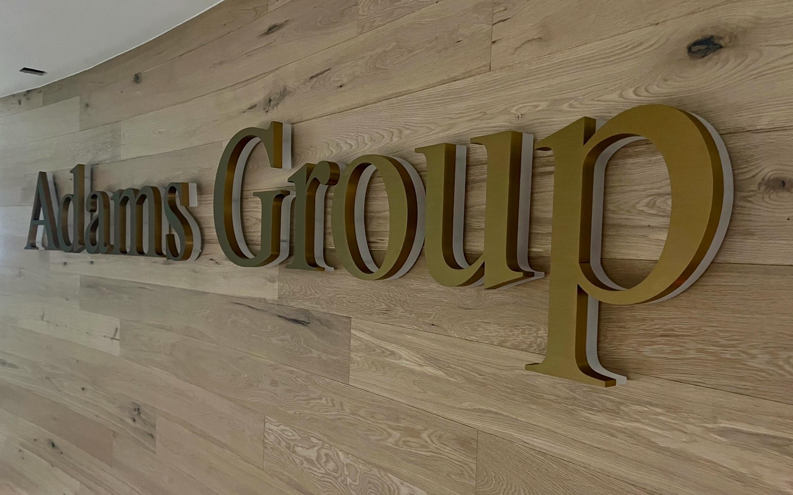 Adams Group Brass fabricated logo with frosted acrylic underneath