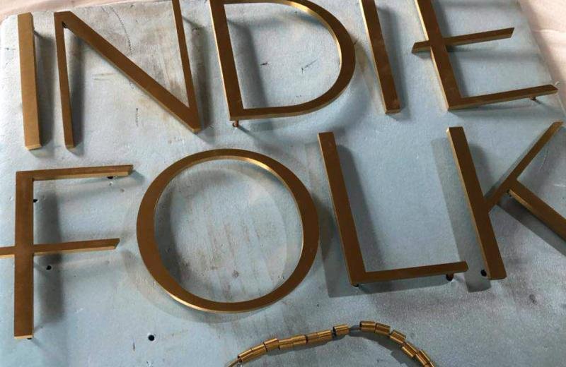 aged-brass-metal-letters-on-pins