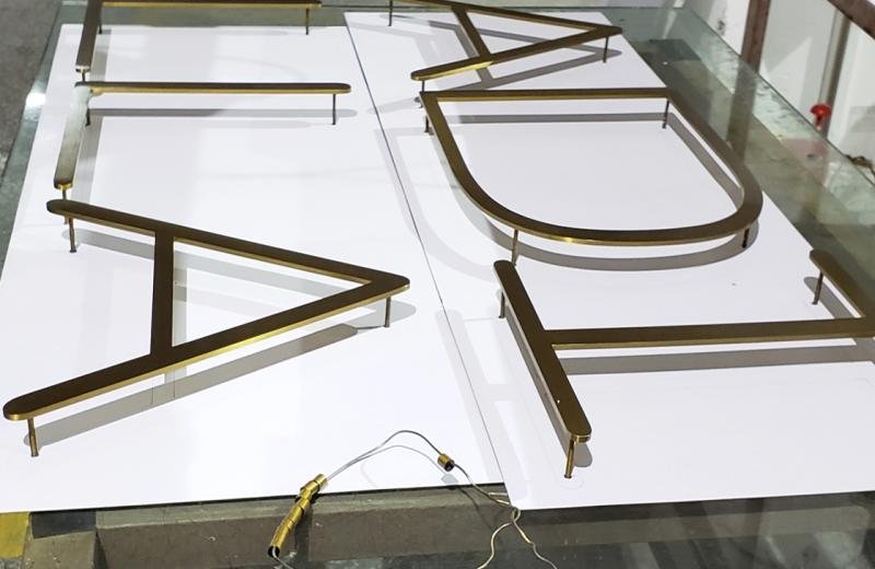 brass-brushed-metal-letters-on-pins