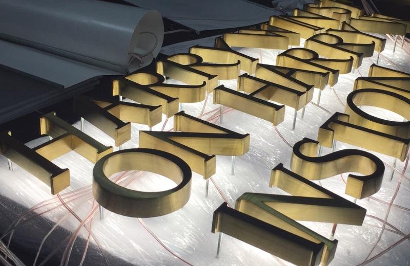 brass-metal-fabricated-letters-with-a-halo-glow-behind