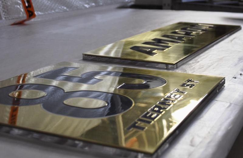 brass-plaque-sitting-on-polished-perspex-base