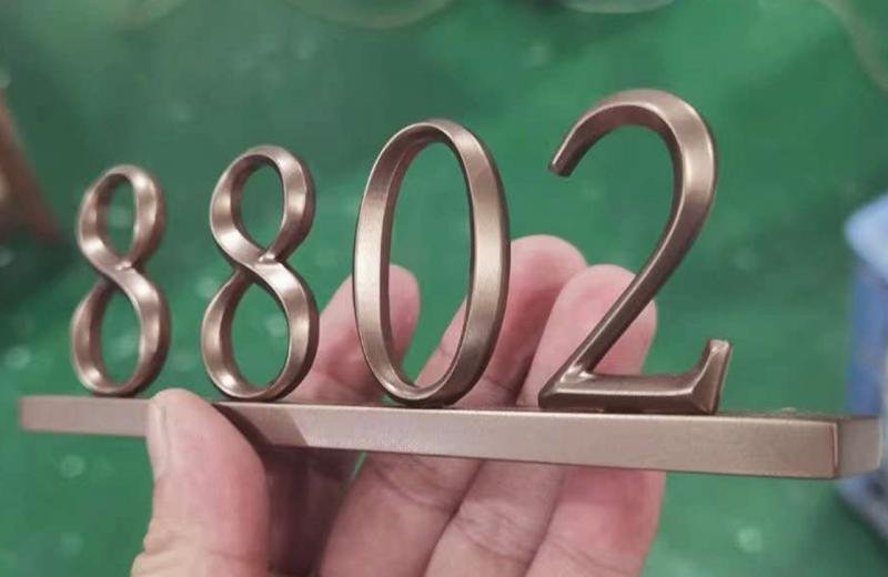 bronze-metal-letter-with-shapes-elevated