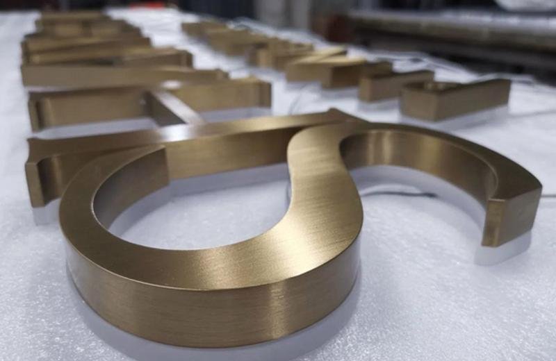 brushed-brass-sign-with-frosted-white-acrylic-under-to-glow