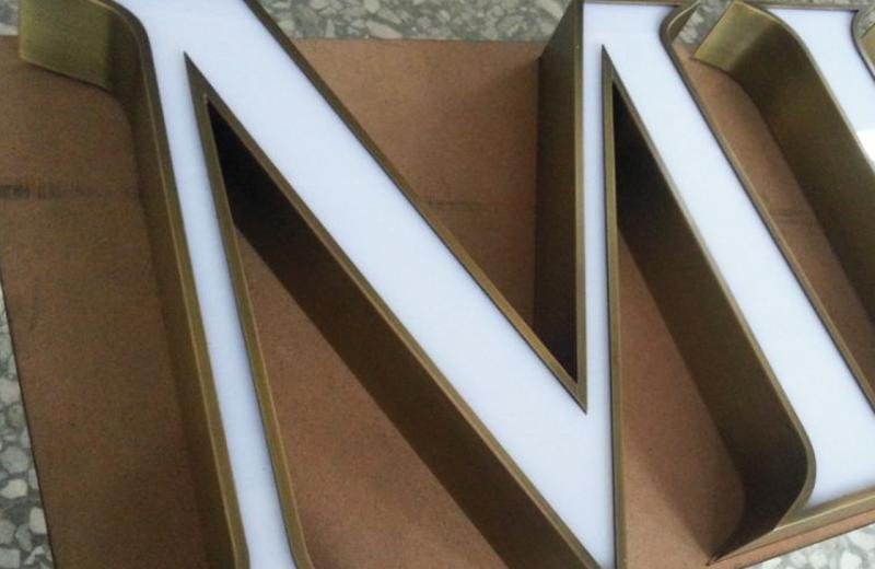 aged-brass-detailed-logo-close-up-fabricated-signage-detail