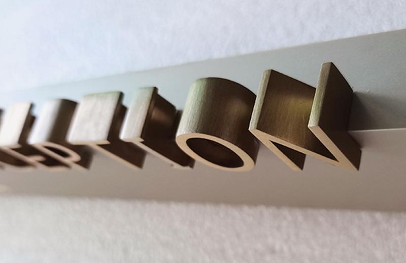 aged-brass-metal-work-sign