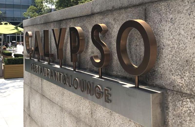 aged-brass-sign-installed-outdoors