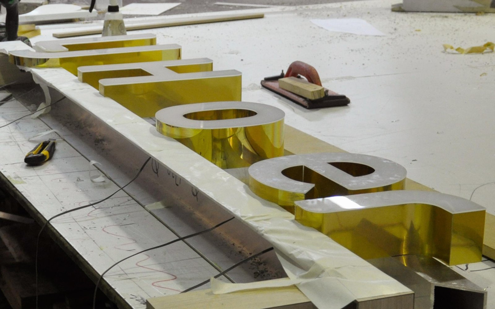 lJ-hooker-brass-signage-being-made